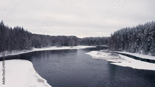 Wallpaper Mural Forest in winter, drone fly over of river and pine trees covered with snow. Aerial drone shot zoom in of winter forest and frozen water under cloudy white sky Torontodigital.ca