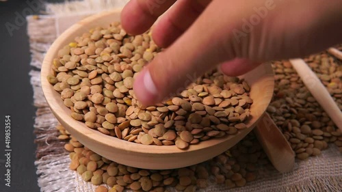brown lentils in wooden bowl. Healthy lifestyle. Vegetarian and vegan diet.
