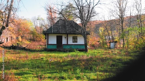 Rural environment with old houses and flock of sheep in autumn season