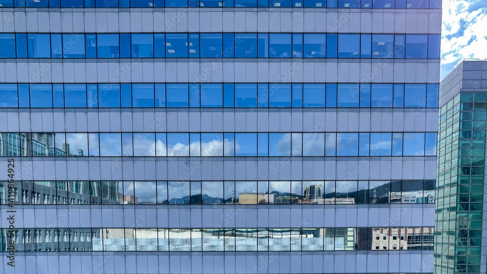 Fototapeta premium Corporate landmark skyline in modern city. Towering glass skyscrapers reflecting