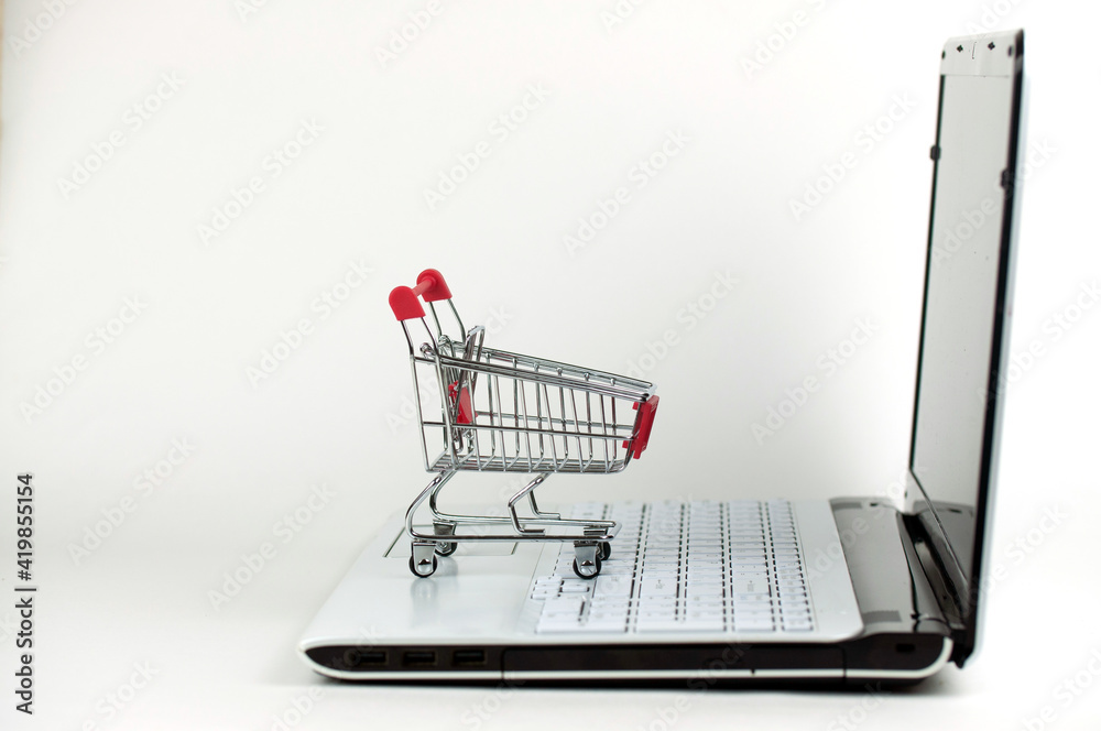the shopping cart on the laptop keyboard, concept online shopping the shopping cart on the laptop keyboard, concept online shopping