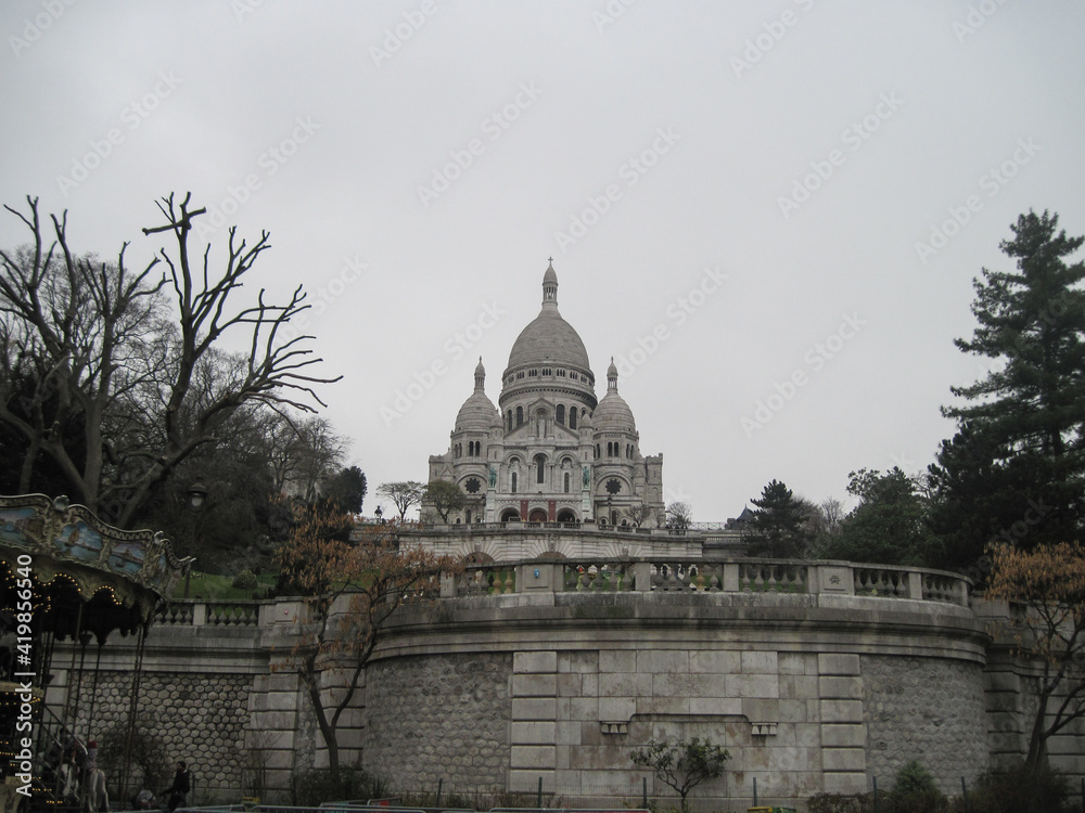 Panorama of the famous cathedral Sacre Coeur on a cloudy day. Scenic view of famous landmark in the morning.