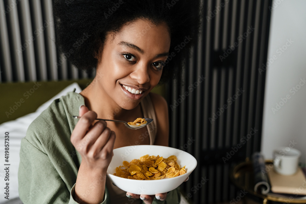 African american young woman eating breakfast African american young woman eating breakfast