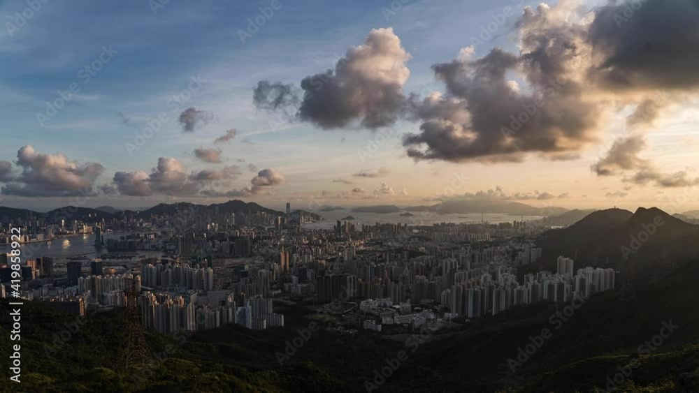 Dramatic clouds timelapse speeding above sunset Kowloon Hong Kong downtown city view skyline