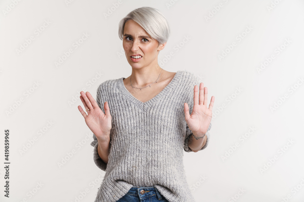 White-haired displeased woman showing stop gesture at camera White-haired displeased woman showing stop gesture at camera