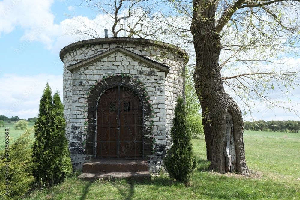 Historic stone chapel of Saint Giles among fields in village of Zrebice, Jura Krakow - Czestochowa, Poland