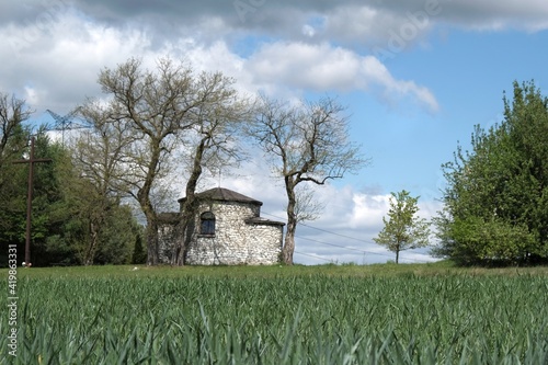 Historic stone chapel of Saint Giles among fields in village of Zrebice, Jura Krakow - Czestochowa, Poland photo