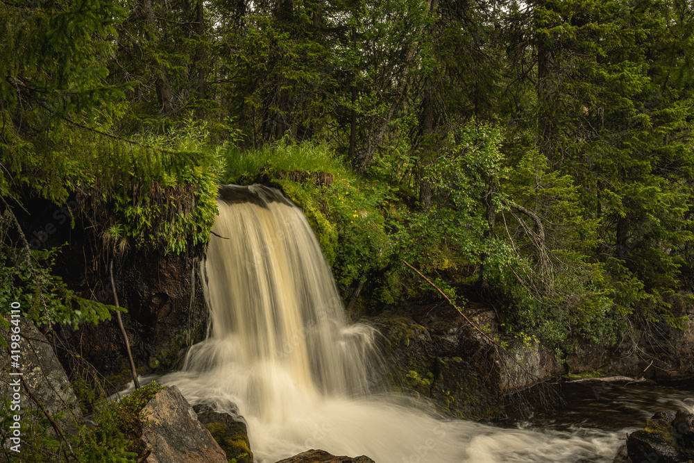 Small waterfall in the middle of a forest in northern Sweden