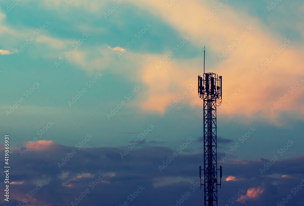 Telecommunication tower with sunset sky