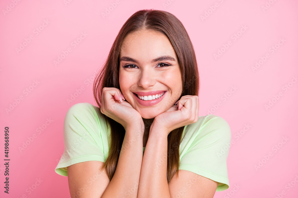 Photo of cute funny young girl dressed green t-shirt arms cheeks isolated pastel pink color background Photo of cute funny young girl dressed green t-shirt arms cheeks isolated pastel pink color background
