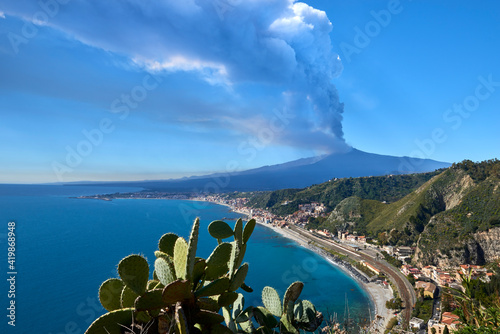 volcano in Sicily taken from the road that climbs to get to Taormina on a beautiful sunny day in spring 2021, you can see the station and Giardini Naxos with the whole 