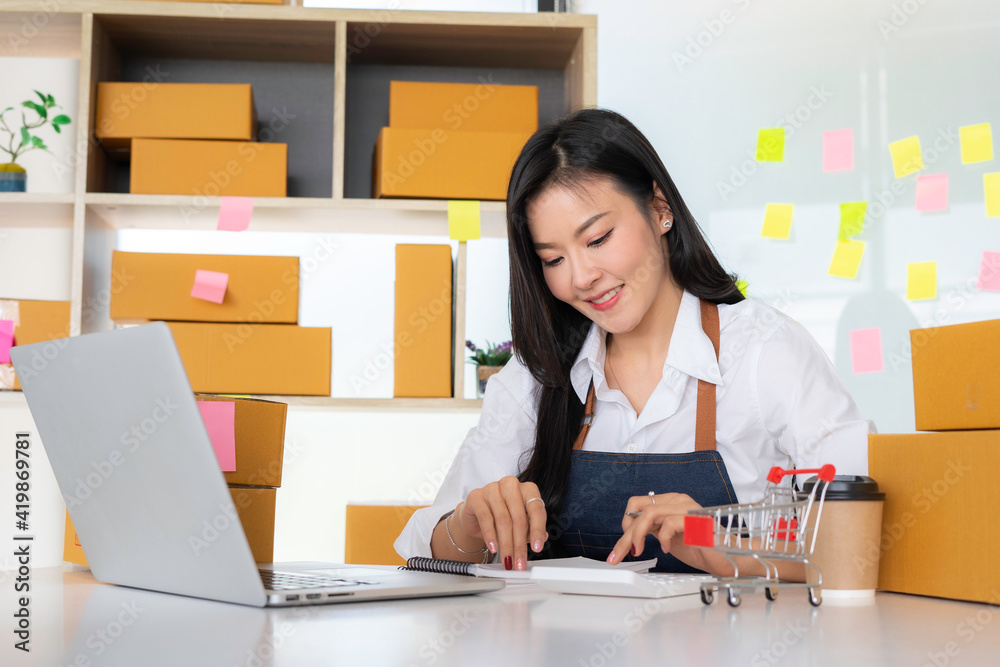 Asian female finance or accountant is pressing the calculator to calculate the company's investment report, the calculation concept. And examine the investment results Asian female finance or accountant is pressing the calculator to calculate the company's investment report, the calculation concept. And examine the investment results