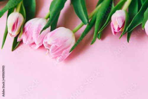 Fototapeta Naklejka Na Ścianę i Meble -  March 8, International Women's Day. number eight, consisting of a cup of coffee and a donut with a pink filling, next to pink tulips on a pink background. space for text