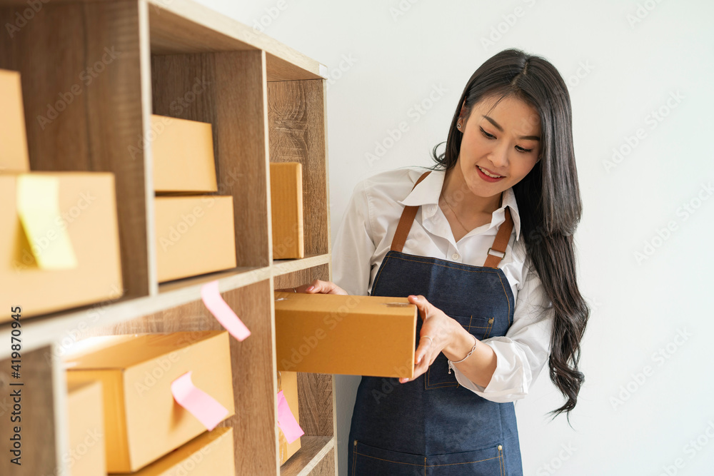 Starting a small business SME owner female entrepreneurs carrying boxes to sort products on the shelves sorted by order. Success in sme business online Starting a small business SME owner female entrepreneurs carrying boxes to sort products on the shelves sorted by order. Success in sme business online