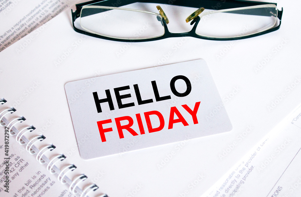 Text Hello Friday on a business card lying on a notepad with eyeglasses and text documents Text Hello Friday on a business card lying on a notepad with eyeglasses and text documents