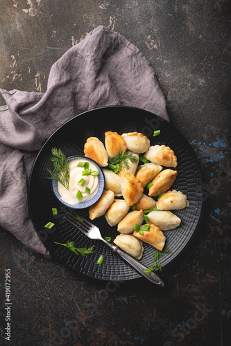 Dumplings, pelmeni, ravioli, pierogi on the table	