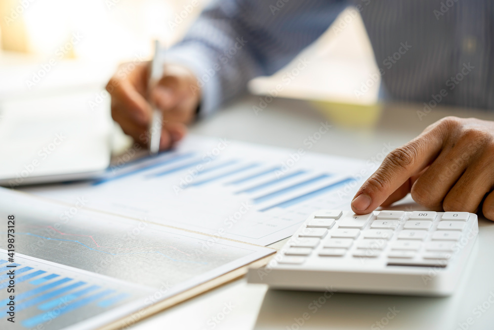 Close up of male accountant or banker making calculations. Savings money, Annual tax calculation finances, and economy concept. Financial calculation concept Close up of male accountant or banker making calculations. Savings money, Annual tax calculation finances, and economy concept. Financial calculation concept