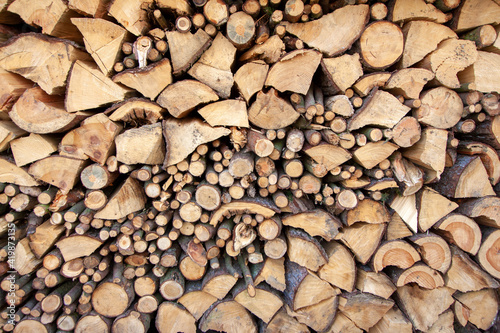 Natural wooden background - detailed chopped firewood.