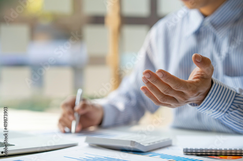 A businessman that operates on the table being checking data, Concept financial transactions online of a businessman, Financier being check about financial transaction past computer with teamwork.