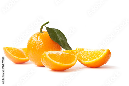 Orange fruit with slices and leaves isolated on white background. Fresh citrus composition.