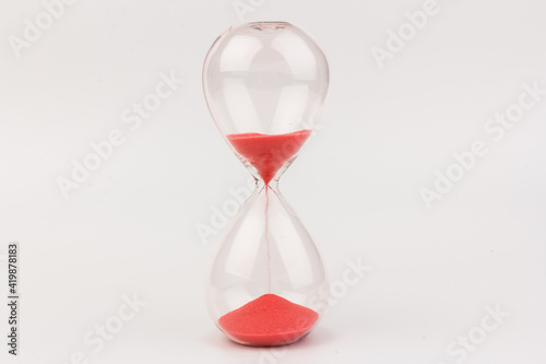 Crystal hourglass on light background as a concept of passing time for business term, urgency and outcome of time.