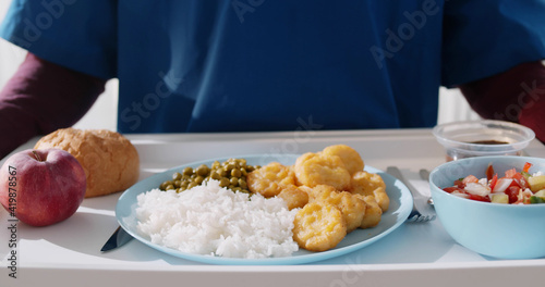 Fotografija Close up of nurse carrying tray with hospital food for patient