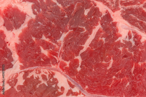 Close view of a raw beef loin boneless end cut strip steak.