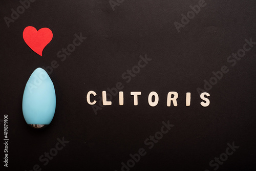 Clitoral vibrator on black background. Copy space photo