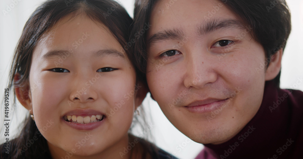 Close up of young asian couple smiling at camera Close up of young asian couple smiling at camera