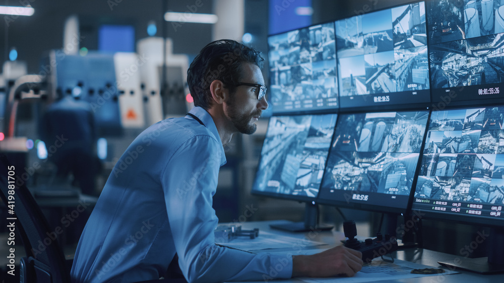 Industry 4.0 Modern Factory: Security Operator Controls Proper Functioning  of Workshop Production Line, Uses Computer with Screens Showing  Surveillance Camera Feed. High-Tech Security Photos | Adobe Stock