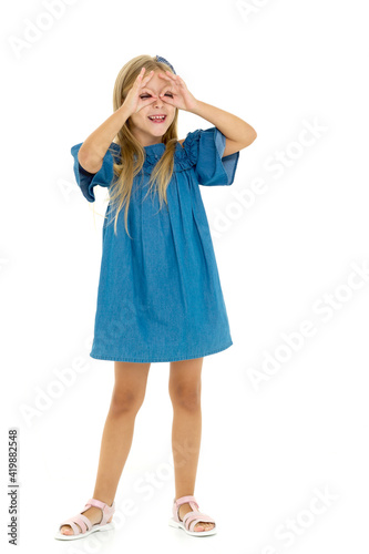 Girl having fun making eyeglasses shape with hands