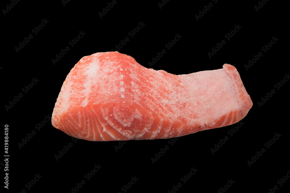 Piece of salmon fish sprinkled black salt