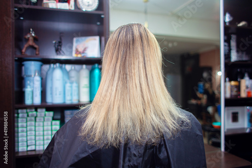 Regrown hair with split ends. The woman came to the hairdresser to dye her hair and cut her hair.
