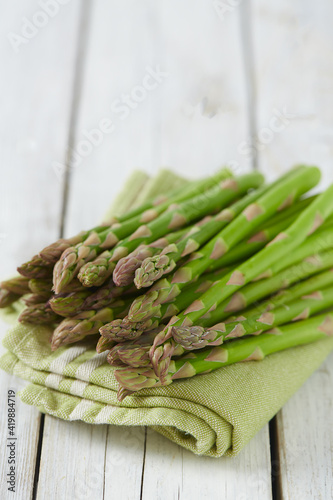 fresh green asparagus on wooden surface photo