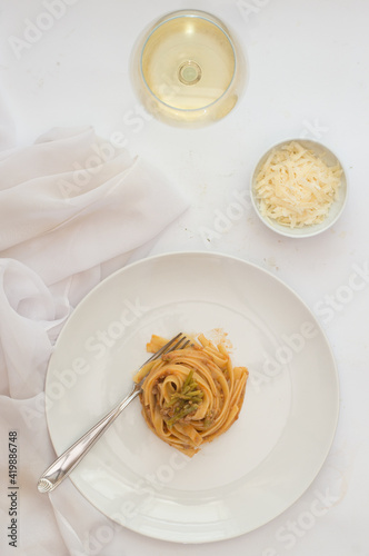 White plate full of spaghetti.