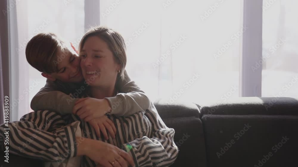 A Happy family. Smiling son boy kid child hugging his mother expressing tender feelings A Happy family. Smiling son boy kid child hugging his mother expressing tender feelings