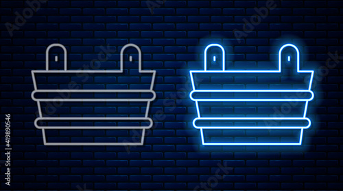 Glowing neon line Sauna bucket icon isolated on brick wall background. Vector