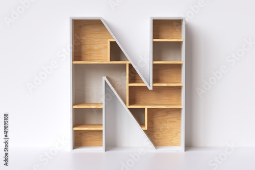 Wood empty bookshelves in the shape of letter “N”, ideal to display retail products or decorate an interior space. White maple and natural pine wood combination. 3D rendering.