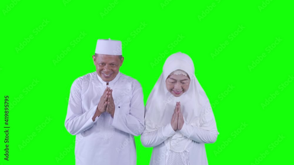 Muslim elderly couple showing congratulate gesture Muslim elderly couple showing congratulate gesture