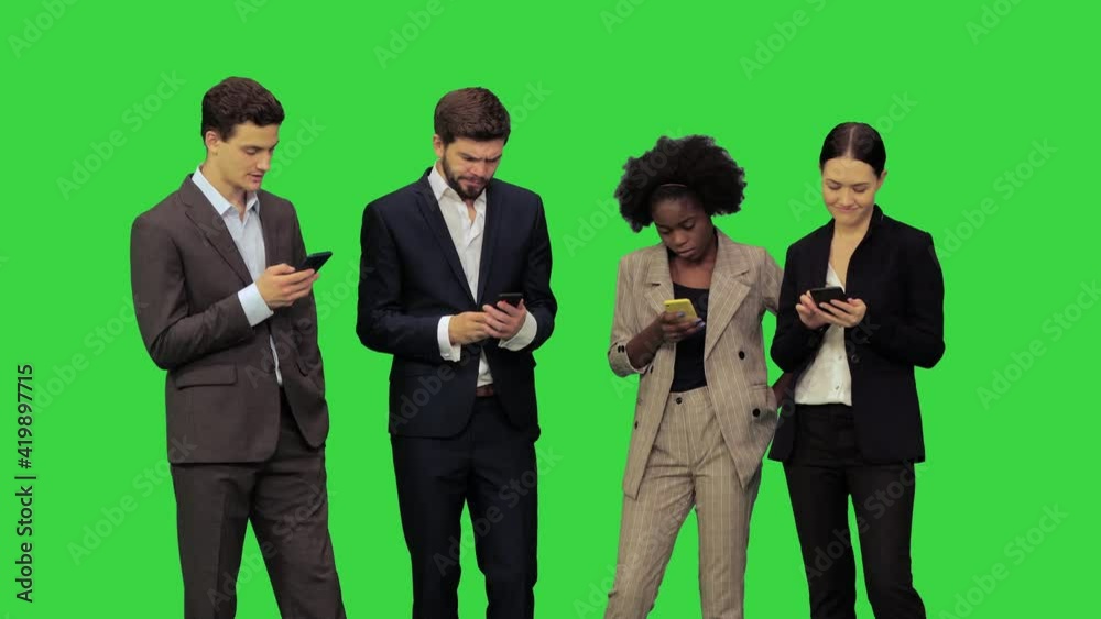 Young business team making phone calls, texting with clients on a Green Screen, Chroma Key. Young business team making phone calls, texting with clients on a Green Screen, Chroma Key.