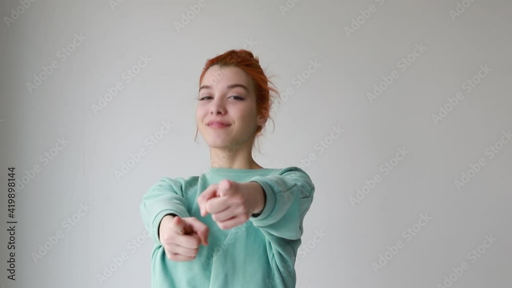 Young woman cheerful and smiling pointing to the front with both hands Young woman cheerful and smiling pointing to the front with both hands