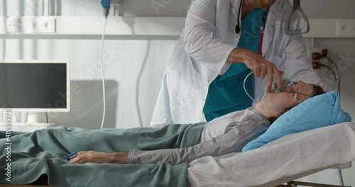 Doctor giving resuscitation to male patient in emergency room photo