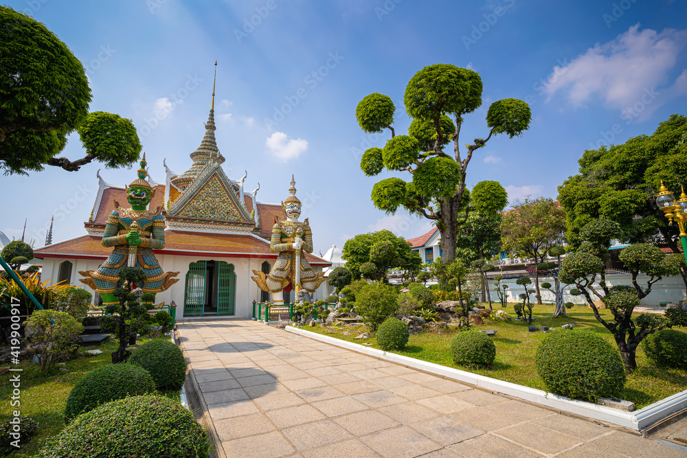 Wat Arun Ratchawararam of giants front of the church and nobody in front Entrance door buddhist temple of tourists and landmark popular tourist attractions and cultural attractions in BANGKOK THAILAND