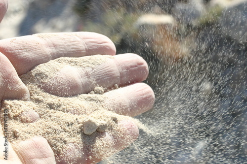 Hand Holding Dust From Impact Barringer Meteor Crater Arizona From Asteroid Hitting Ground in Arizona photo