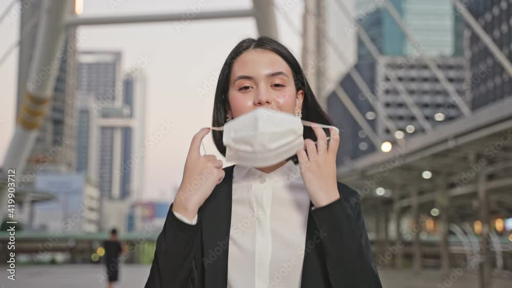 Portrait of Asian young businesswoman taking off face mask and smile. Portrait of Asian young businesswoman taking off face mask and smile.