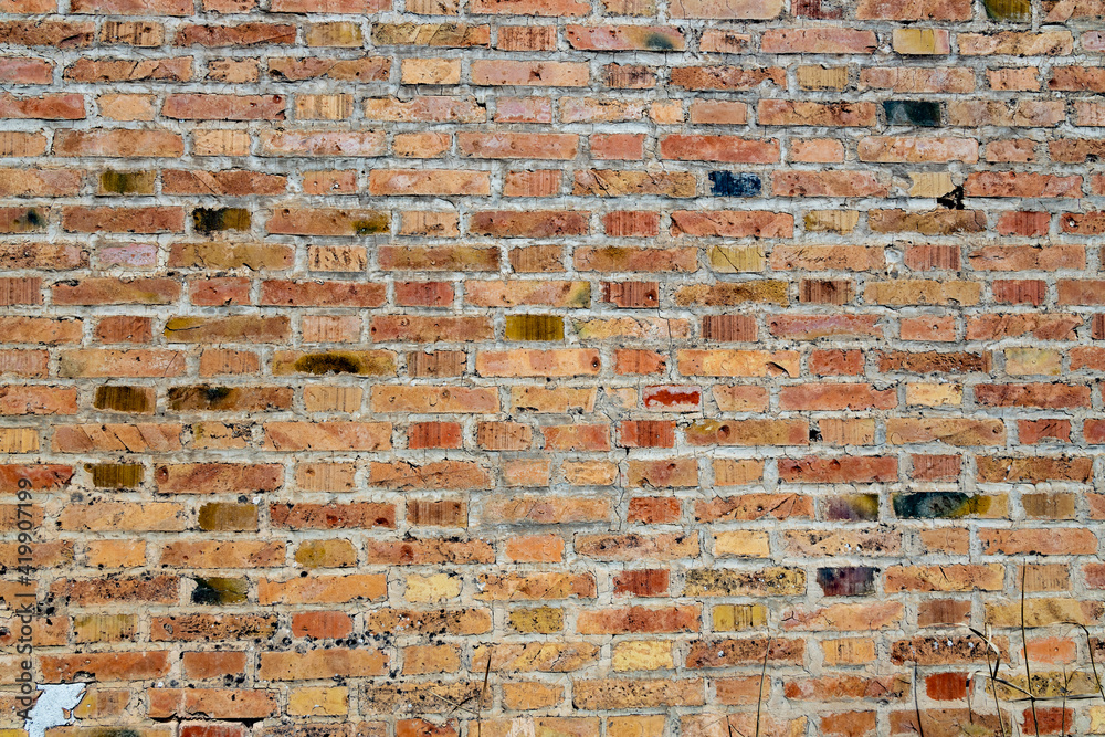 Symmetrical brick wall background. Red and brown colored terracotta bricks  from an abandoned house, some clean, some dirty. Cracks in the wall. Stock  Photo | Adobe Stock