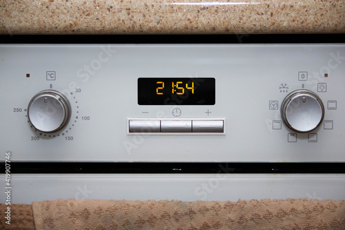 white oven in the kitchen with built-in clock 