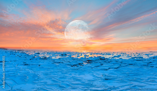 Beautiful winter landscape on frozen seashore with full moon during sunset - Tromso  Norway  Elements of this image furnished by NASA 