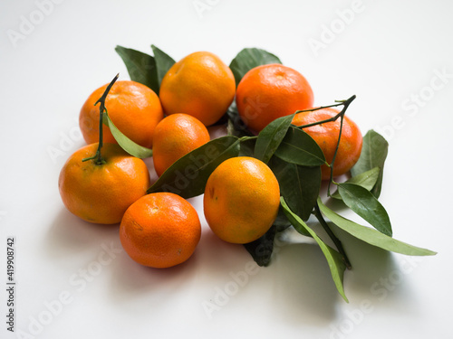 Tangerines with leaves on a white background. Chinese sweet tangerines