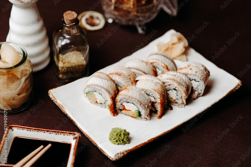Set of sushi golden dragon on a clay plate Set of sushi golden dragon on a clay plate